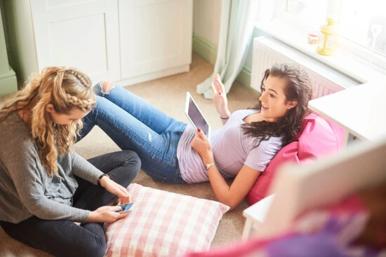 Two girls talking in their dorm