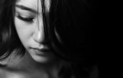 Black and white image of girl looking depressed